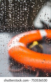 Orange Life Preserver On A Boat During A Rain Storm, Shallow Depth Of Field