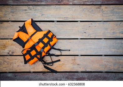 Orange Life Vest On Wooden Background