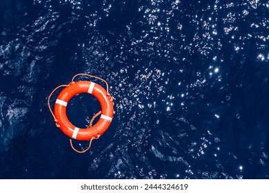 Orange lifebuoy floating on the surface of the ocean, needed help for those who fall overboard. 