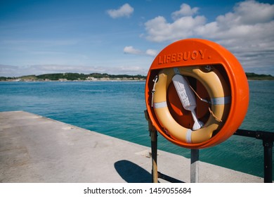 Orange Lifebuoy On Harbour Wall