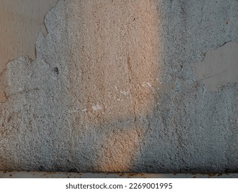 Orange light shadow reflected on old cement wall with shadow lines for vintage background.