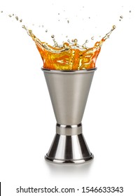 Orange Liquor Spilling Out Of A Jigger Isolated On White Background