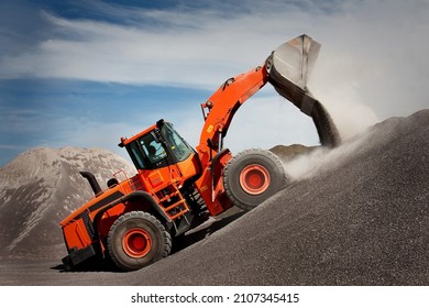 the orange loader is loading the aggregate