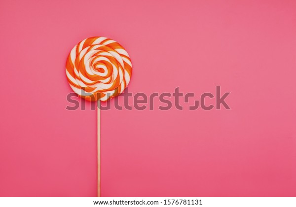 Orange Lollipop On Pink Background Soft Stock Photo (Edit Now) 1576781131