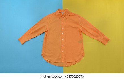 Orange Long Sleeve.shirt On Yellow, Blue Background 

