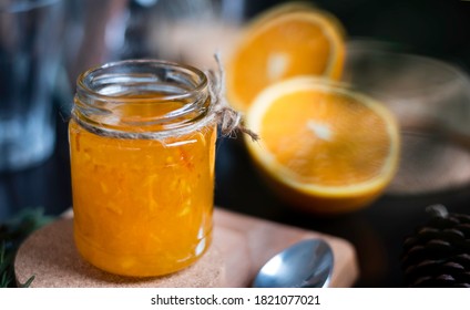 Orange marmalade / orange jam in glass jar. A confiture is any fruit jam, marmalade, paste or fruit stewed in thick syrup. Orange marmalade & fruit jam in glass jar concept. Dark food photography. 