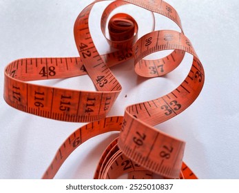 Orange measuring tape. Close up measuring tape. measurement and precicion. Red tape measure spiral creates a visual impression of 
motion. measuring tape isolated.  - Powered by Shutterstock