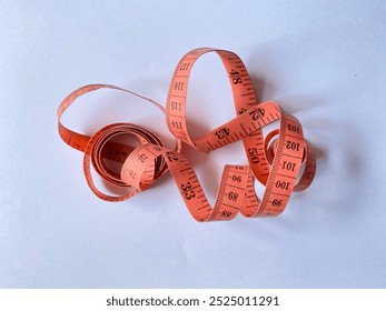 Orange measuring tape. Close up measuring tape. measurement and precicion. Red tape measure spiral creates a visual impression of 
motion. on white background. measuring tape isolated.  - Powered by Shutterstock