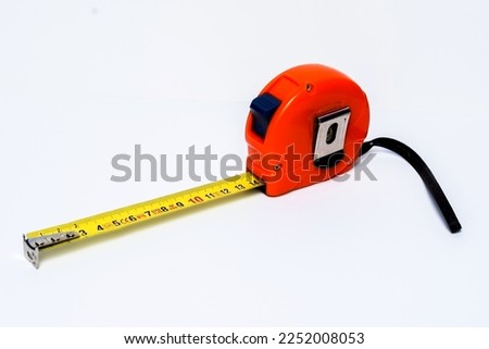Orange measuring tape isolated cut out on white background.