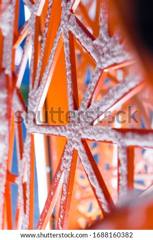 Orange meatl art object in the form of frame, decoration covered snow. Expanded metal railing Stock photo © 