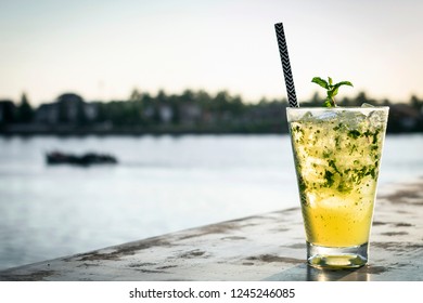 Orange Mojito Summer Cocktail Drink On Outdoor Riverside Bar Tabe