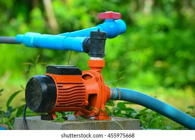 Orange Motor Water Pump In The Garden