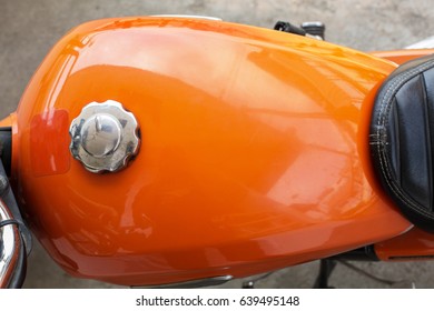 An Orange Motorcycle Fuel Tank.