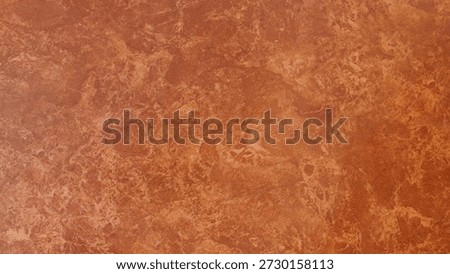 Orange mottled texture background, abstract terracotta surface with artistic paint effect.