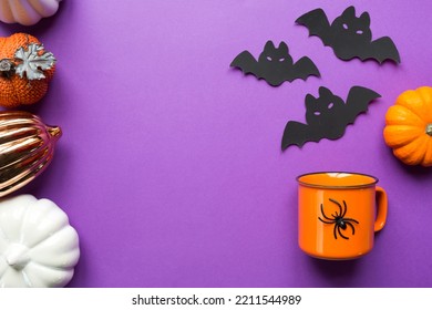 Orange Mug On A Purple Background With Terrible Halloween Decorations. The Concept Of The Halloween Holiday. Drink, Fun, Party. Copy Space, Mock Up, Flatly