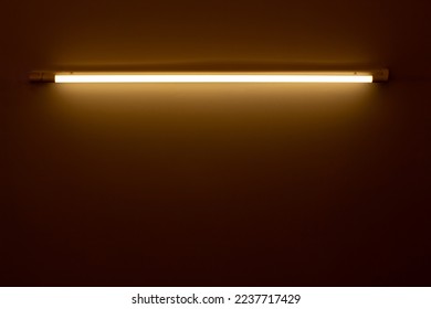 orange neon lamp on a white wall