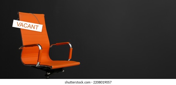Orange office chair with sign VACANT on black background, space for text. Banner design