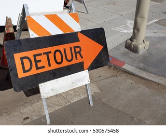 Orange On Black Detour Arrow At Street Repair. Horizontal.