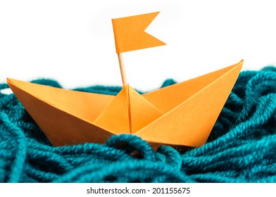 Orange Origami Paper Boat In The Yarn Sea Isolated On White