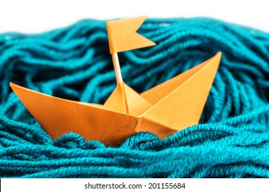 Orange Origami Paper Boat In The Yarn Sea Isolated On White