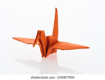 Orange Origami Paper Crane On White Background.