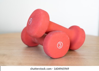 Orange Pair Of Three Pound Free Weights For Exercise