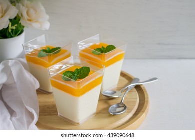 Orange Panna Cotta On White Wood Table.