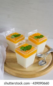 Orange Panna Cotta On White Wood Table.