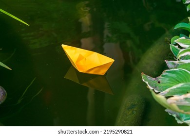 Orange Paper Boat In Home Pond