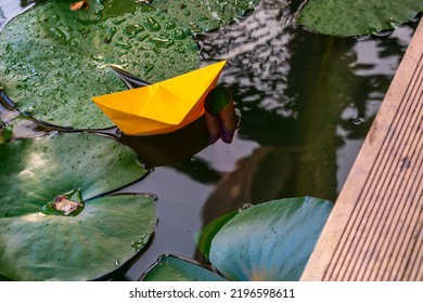 Orange Paper Boat In Home Pond