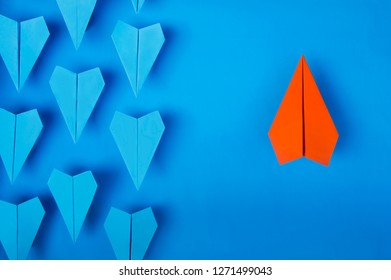 Orange Paper Plane Fly Up And Other Blue Planes Fly Down,  Innovation And Think Different Concept