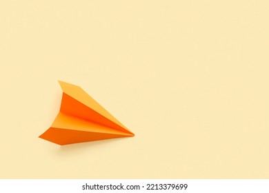 Orange Paper Plane On Beige Background