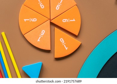 Orange pieces of fractions on a table. Close up math material for study. Back to school, geometry lessons, mathematical education for preschooler. Creative study. background with numbers - Shutterstock ID 2191757689
