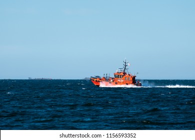 Orange Pilot Boat At Speed