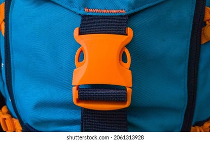 Orange plastic belt clip, buckle fastex, length adjusters on bag or backpack strap, fasteners for paracord bracelet
