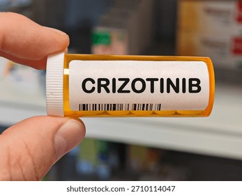 orange plastic Box of CRIZOTINIB tablets on a hospital pharmacy table used to treat non small cell lung cancer an ALK inhibitor. PHARMACY warehouse