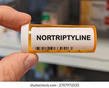 orange plastic Box of NORTRIPTYLINE tablets on a hospital pharmacy table used to treat depression a tricyclic antidepressant. PHARMACY warehouse