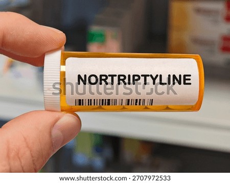 orange plastic Box of NORTRIPTYLINE tablets on a hospital pharmacy table used to treat depression a tricyclic antidepressant. PHARMACY warehouse