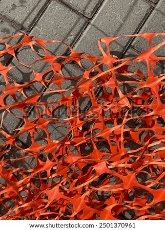 Orange plastic mesh in several random layers