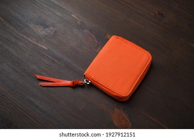 Orange Pocket Purse Bag On Wood Table Background. Small Fabric Cosmetic Bag Or Wallet Bag.