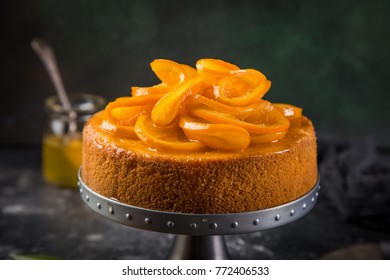 Orange Polenta And Almond  Cake Decorated With Candied Orange Slices, Dark Background. Selective Focus