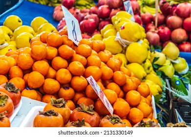 orange, pomegranate, date, quince are sold in the store. Harvest on the market counter. price hike or discount in the market. - Shutterstock ID 2131330149