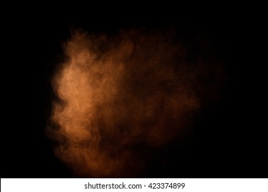 Orange powder explosion on black background. Colored  cloud. Colorful dust explode. Paint Holi. - Shutterstock ID 423374899