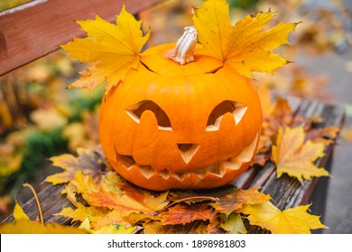 Orange pumpkin for halloween on a bench outside.Halloween concept.