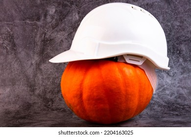 Orange pumpkin and white construction helmet, hard hat. - Shutterstock ID 2204163025
