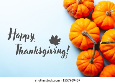 Orange Pumpkins On Blue Background With Happy Thanksgiving Greetings