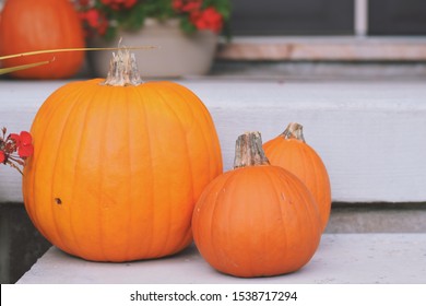 Orange Pumpkins On A Front Steps Of A House Porch