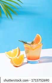Orange Punch Cocktail Cold And Refreshing With Orange Slice On Color Background. Summer Drink.