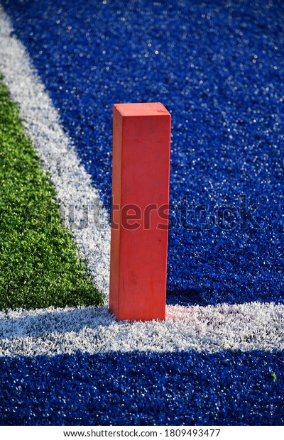 Orange pylon in\
the end zone of a football\
field