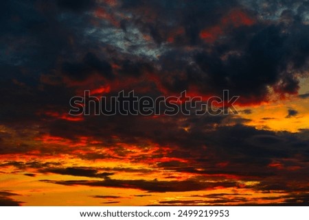 Orange, red and black clouds in the sunset sky